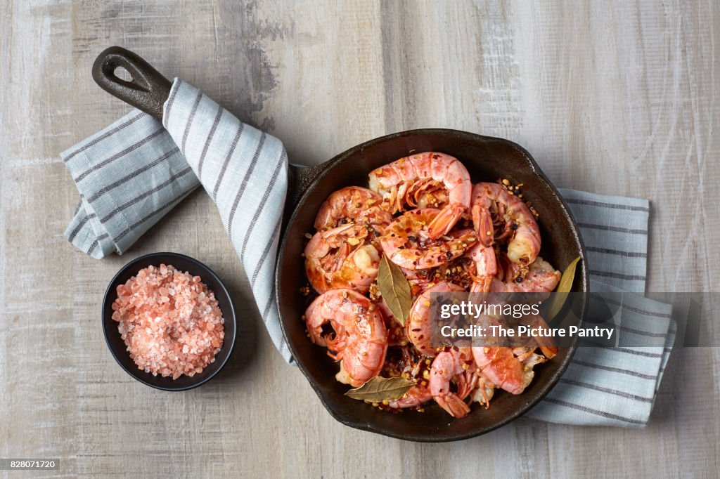 Cooked red shrimp on a light background. Prepared in a frying pan