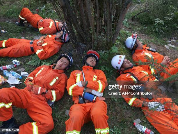 Chinese paramilitary police sleep on the ground after an 18-hour rescue operation in Jiuzhaigou in China's southwestern Sichuan province on August 9,...