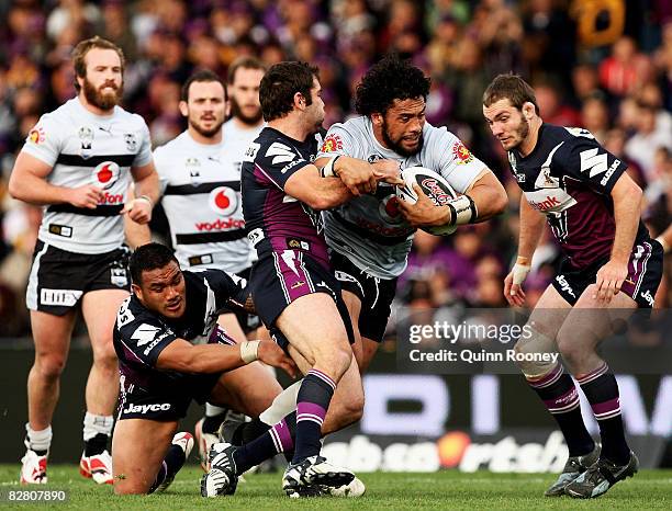 Ruben Wiki of the Warriors is tackled by Cameron Smith of the Storm during the fourth NRL qualifying final match between the Melbourne Storm and the...