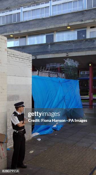 The Wood Dene Community Centre, Peckham, south east London Monday August 29, 2005 is shielded by blue plastic sheeting and cordoned off by police...