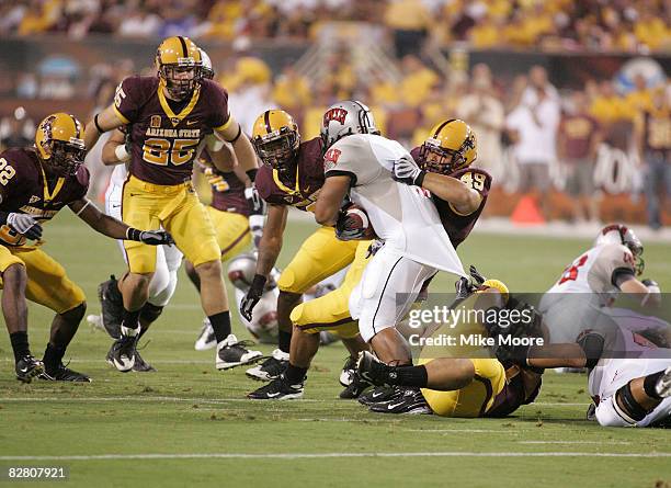 Frank Summers of the UNLV Rebels fights for some tough yards against the Arizona State defense during the UNLV Rebel Arizona State Sun Devils game at...