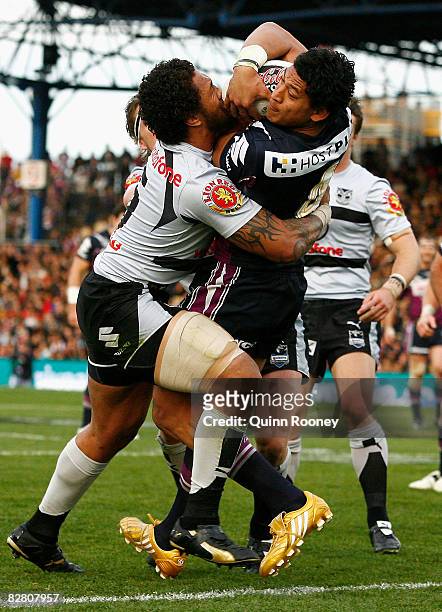 Israel Folau of the Storm is tackled by Manu Vatuvei of the Warriors during the fourth NRL qualifying final match between the Melbourne Storm and the...