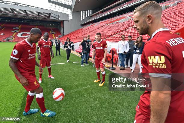 For the Launch of the Western Union partnership Sadio Mane, James Milner, Jordan Henderson and Georginio Wijnaldum of Liverpool wear the shirts with...