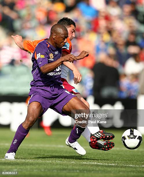 Amaral of the Glory and Charles Miller of the Roar contest the ball during the round four A-League match between the Perth Glory and the Queensland...