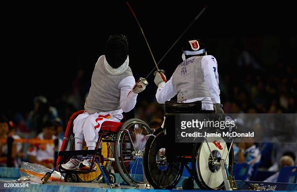 Daoliand Hu of China fences with Laurent Francois Laurent of France in the Individual Foil Category B Final in the Wheelchair Fencing Competition at...