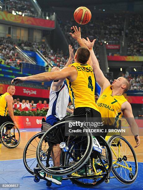 Great Britain's Shaun Norris vies for the rebound with Australia's Justin Eveson and Shaun Norris in their men's wheelchair basketball semifinal...