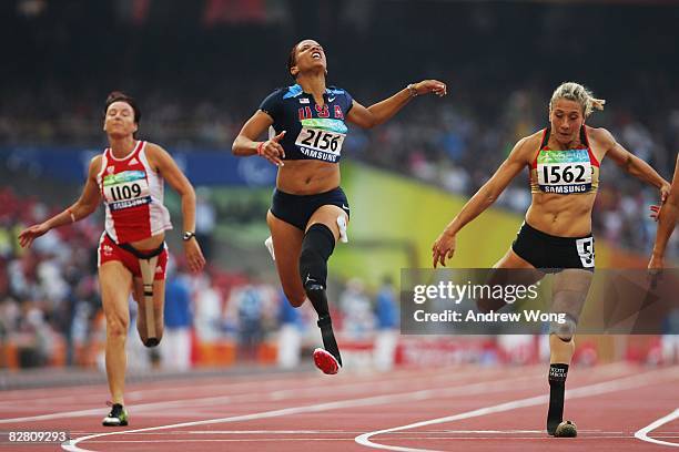 April Holmes of the United States crosses the finish line ahead of Andrea Scherney of Austria and Katrin Green of Germany to winning the final of the...