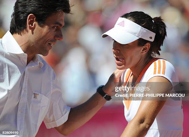 Spanish Anabel Medina speaks with the referee as she competes against Russian Svetlana Kuznetsova during the third Fed Cup World Group Final tennis...