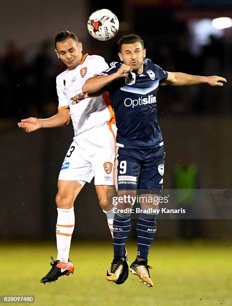 Jade North of the Roar and Kosta Barbarouses of the Victory compete for the ball during the FFA Cup round of 32 match between the Brisbane Roar and...