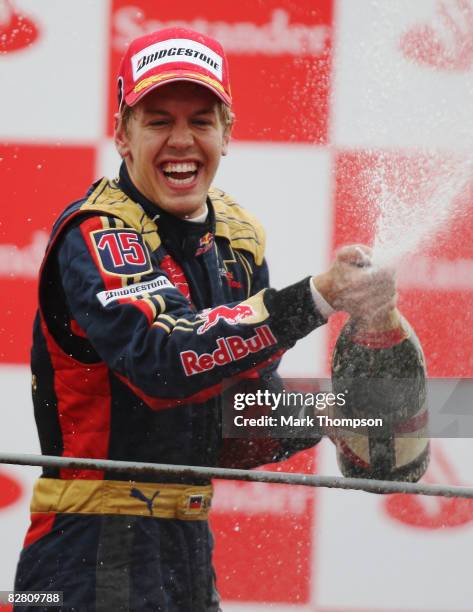 Sebastian Vettel of Germany and Scuderia Toro Rosso celebrates on the podium after winning the Italian Formula One Grand Prix at the Autodromo...