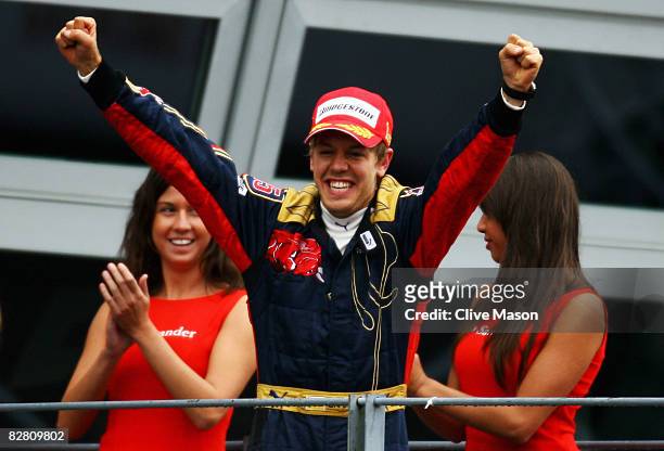 Sebastian Vettel of Germany and Scuderia Toro Rosso celebrates on the podium after winning the Italian Formula One Grand Prix at the Autodromo...