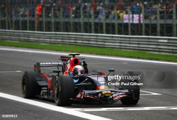 Sebastian Vettel of Germany and Scuderia Toro Rosso celebrates as he crosses the finish line to win the Italian Formula One Grand Prix at the...