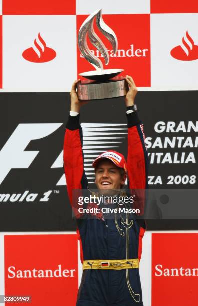 Sebastian Vettel of Germany and Scuderia Toro Rosso celebrates on the podium after winning the Italian Formula One Grand Prix at the Autodromo...