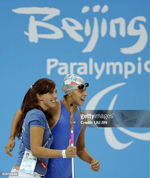 Maria Poiani Panigati of Italy celebrates with her trainer after winning the women's 50m freestyle S11 final during the 2008 Beijing Paralympic Games...