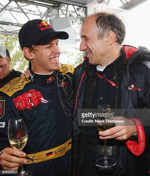 Sebastian Vettel of Germany and Scuderia Toro Rosso celebrates with Scuderia Toro Rosso Team Principal Franz Tost in the paddock after winning the...