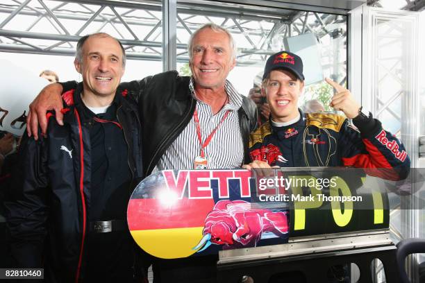 Sebastian Vettel of Germany and Scuderia Toro Rosso celebrates with Red Bull tycoon Dieter Mateschitz and Scuderia Toro Rosso Team Principal Franz...