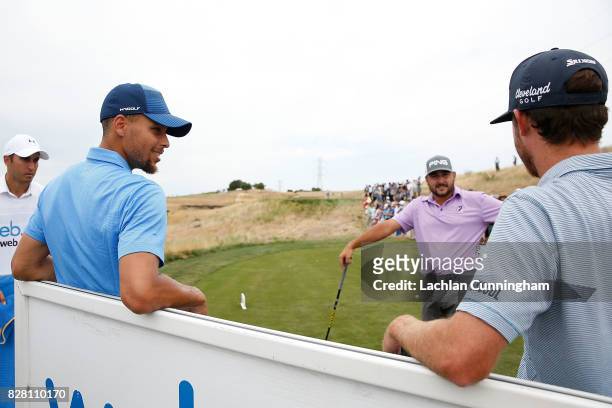 Stephen Curry chats to playing partners Sam Ryder and Stephan Jaeger of Germany at the ninth tee during round one of the Ellie Mae Classic at TCP...