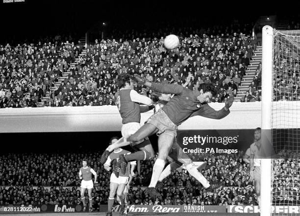 Arsenal striker Malcolm Macdonald and West Ham goalkeeper Mervyn Day jump for a high ball in the London "derby" First Division Match at Highbury.