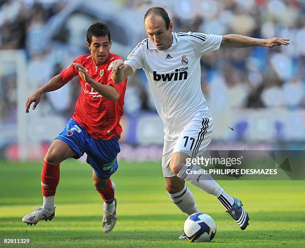 Real Madrid's Dutch Arjen Robben fights for the ball with Numancia's Mario Martinez during their Spanish league football match at the Santiago...