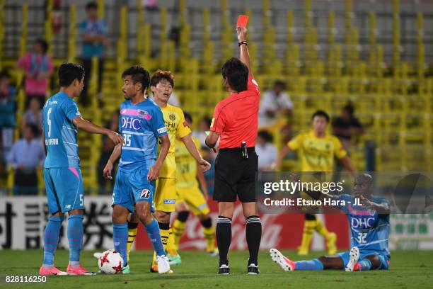 Kim Bo Kyung of Kashiwa Reysol is shown a red card by referee Nobutsugu Murakami after fouling on Victor Ibarbo of Sagan Tosu during the J.League J1...
