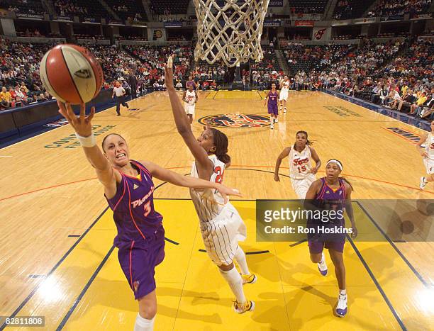 Diana Taurasi of the Phoenix Mercury lays the ball up against Tamika Catchings of the Indiana Fever at Conseco Fieldhouse September 14, 2008 in...