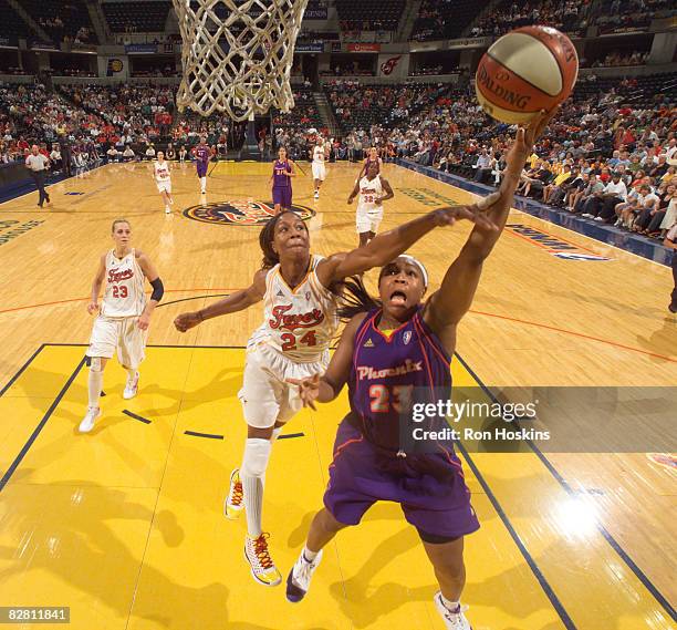 Cappie Pondexter of the Phoenix Mercury lays the ball up against Tamika Catchings of the Indiana Fever at Conseco Fieldhouse September 14, 2008 in...