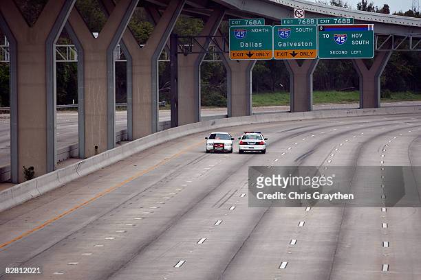 Members of the Houston Police deparment block off Interstate 10 due to flooding from Hurricane Ike September 14, 2008 in Houston, Texas. Ike caused...