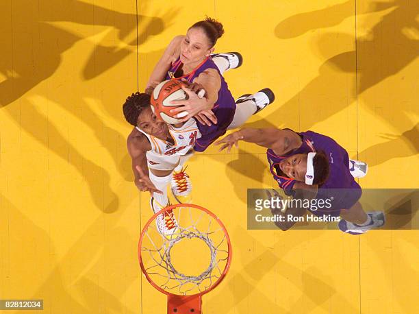 Tamika Catchings of the Indiana Fever battles Diana Taurasi and Cappie Pondexter of the Phoenix Mercury at Conseco Fieldhouse September 14, 2008 in...