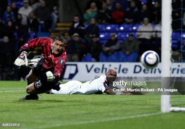 Bolton Wanderers' El Hadji Diouf scores past Lokomotiv Plovdiv's goalkeeper Stoyan Kolev during the UEFA Cup first round match at the Reebok Stadium,...
