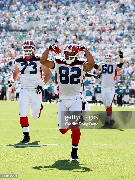 Wide receiver Josh Reed and lineman Kirk Chambers of the Buffalo Bills run to celebrate with and James Hardy after a tochdown catch by Hardy late in...