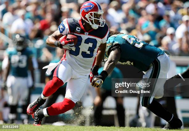 Wide receiver Lee Evans of the Buffalo Bills gets past linebacker Mike Peterson of the Jacksonville Jaguars at Jacksonville Municipal Stadium on...