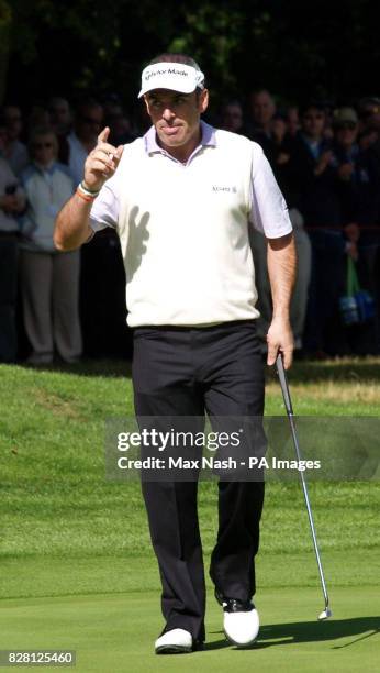 Ireland's Paul McGinley celebrates a putt during his semi-final against Argentina's Angel Cabrera in the third day of the HSBC World Match Play...