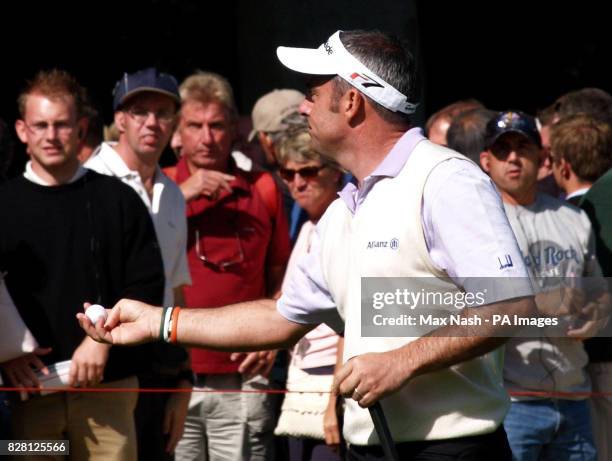 Ireland's Paul McGinley offers his ball to a fan after winning his semi-final against Argentina's Angel Cabrera during the third day of the HSBC...