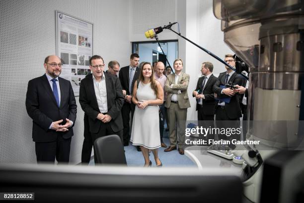 Candidate for the german chancellorship of the Social Democratic Party of Germany , Martin Schulz , speaks with a scientist in a laboratory during...