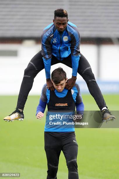 August 09: Wilfred Ndidi jumps over Ben Chilwell on the way out to training during the Leicester City training session at Belvoir Drive Training...