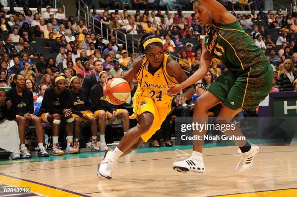 Marie Ferdinand-Harris of the Los Angeles Sparks drives the ball against Ashley Robinson of the Seattle Storm on September 14, 2008 at Staples Center...
