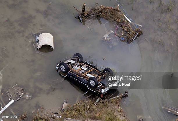 An overturned car sits in floodwaters from Hurricane Ike September 14, 2008 in Gilchrist, Texas. Floodwaters from Hurricane Ike are reportedly as...