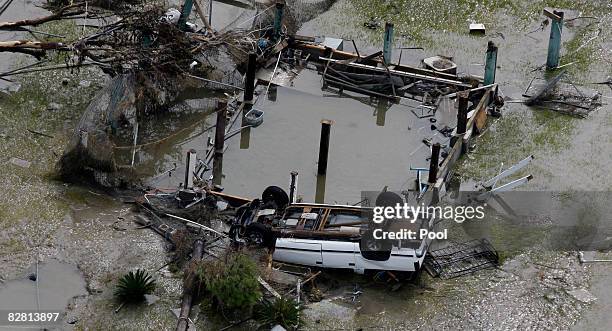 Turned over car sits among debris from Hurricane Ike September 14, 2008 in Gilchrist, Texas. Floodwaters from Hurricane Ike are reportedly as high as...