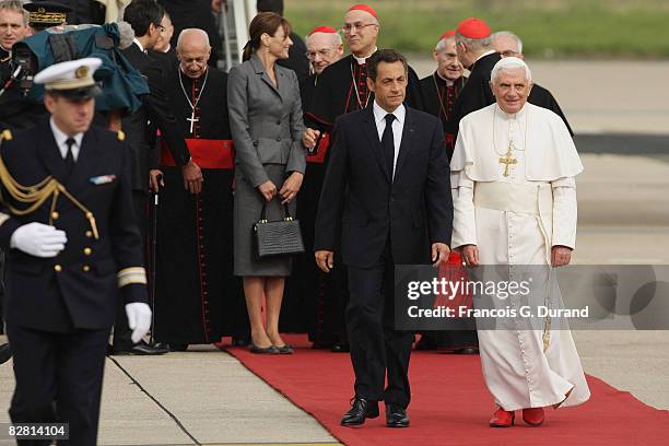 Pope Benedict XVI arrives at Orly airport welcomed by French President Nicolas Sarkozy and his wife Carla Bruni-Sarkozy, on September 12, 2008 in...