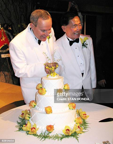 Actor George Takei and partner Brad Altman prepare to cut the cake after they were married at the Japanese American National Museum on September 14,...
