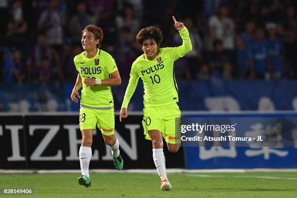 Yosuke Kashiwagi of Urawa Red Diamonds and Daisuke Kikuchi of Urawa Red Diamonds celebrate their opening goal during the J.League J1 match between...