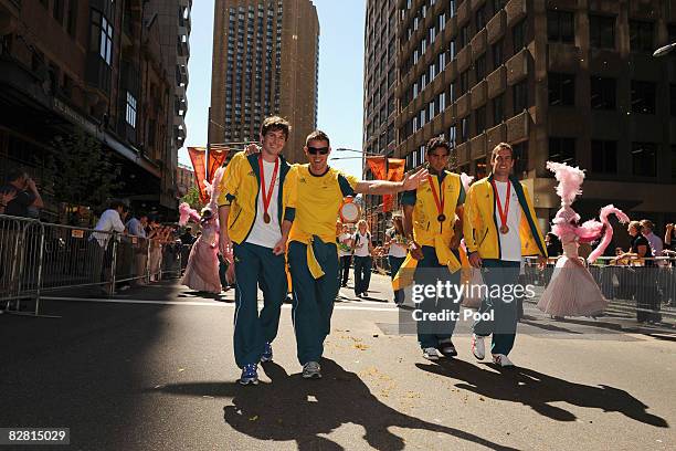 Members of Australia's bronze medal-winning men's hockey team wave to the crowd during a welcome home parade for the Beijing 2008 Olympic Athletes on...
