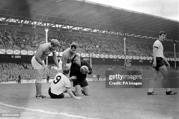 West Germany's Uwe Seeler shakes hands with USSR goalkeeper Lev Yashin after challenging him for the ball as USSR's Albert Shesterniev and Vasily...