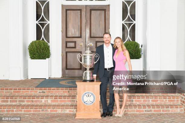 Champion, Jimmy Walker with his wife Erin gather with the Wanamaker Trophy during the ChampionÕs Dinner for the 99th PGA Championship held at Quail...