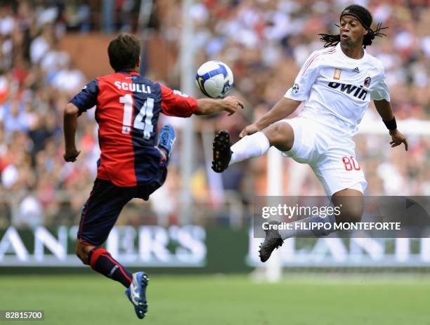 Milan's forward Ronaldinho fights for the ball with Genoa's forward Giuseppe Sculli during their Serie A football match at Genoa's Luigi Ferraris...