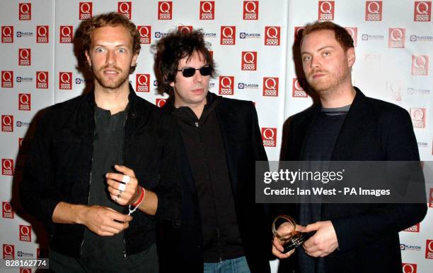 Ian McCulloch of Echo and the Bunnymen with Coldplay singer Chris Martin and guitarist Jonny Berryman displaying Coldplay's award for Best Act in the...