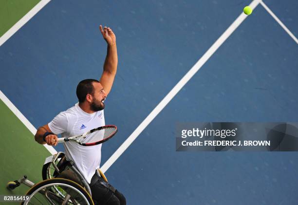 Michael Jeremiasz of France tosses the ball to serve while playing with partner Stephane Houdet against Sweden's Stefan Olsson and Peter Wikstrom in...