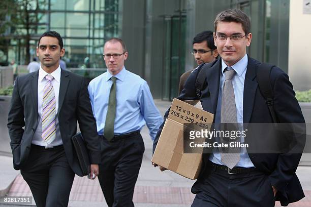Men leave Lehman Brothers' Canary Wharf office on September 15, 2008 in London, England. The fourth largest American investment bank has announced...