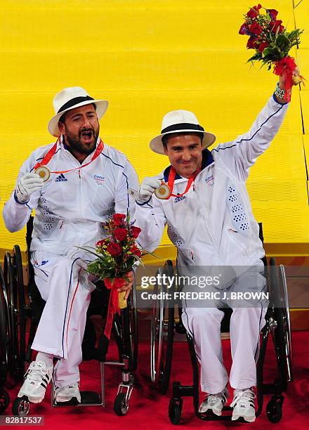 Michael Jeremiasz and Stephane Houdet of France hold their gold medals following victory over Sweden's Stefan Olsson and Peter Wikstrom in the men's...