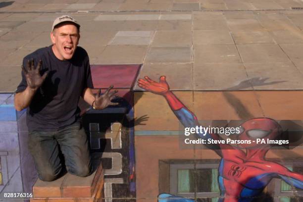 Street artist Julian Beever working on his 3-D cityscape at the launch of the Ultimate Spider-Man comic strip console game in central London.